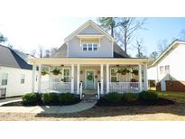 Charming home featuring a light blue door, inviting front porch and beautifully landscaped front yard at 206 Pine St, Fuquay Varina, NC 27526