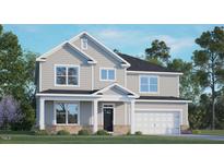 Charming two-story home featuring a classic gray exterior, well-manicured lawn and a welcoming covered front porch at 265 Umstead St, Sanford, NC 27330