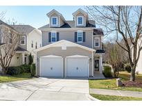 Charming two-story home featuring a two-car garage, dormer windows, and manicured lawn at 3038 Remington Oaks Cir, Cary, NC 27519