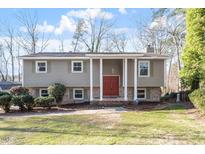 Charming two-story home featuring a red front door, brick accents, and a welcoming front yard at 305 Cliffview Dr, Knightdale, NC 27545