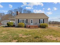 Charming single-story home with manicured bushes and a quaint brick entryway at 3307 Altamahaw Church St, Elon, NC 27244
