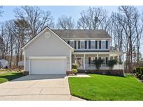 Charming two-story home with a large front yard and a welcoming front porch at 4904 Goosedown Ct, Raleigh, NC 27604