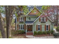 Charming two-story home featuring a gabled roof, wood shutters and trim, and manicured landscaping at 5504 Quails Call Ct, Garner, NC 27529