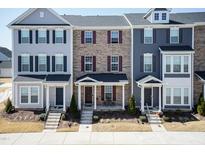 Charming townhome exterior with covered entryway and well-maintained landscaping at 5917 Kayton St, Raleigh, NC 27616