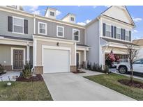 Charming townhome featuring a garage and a well-maintained lawn, perfect for comfortable living at 63 Pale Moss Dr, Clayton, NC 27527