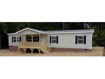 Charming single-story home with a inviting front porch and neutral siding at 6646 Woodlawn Dr, Oxford, NC 27565