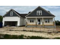 New construction home featuring white siding, dark roof, and a covered porch at 896 Olive Branch Dr, Smithfield, NC 27577