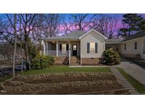 Charming single-Gathering home featuring a welcoming front porch and landscaped yard at 1024 Onslow St, Durham, NC 27705