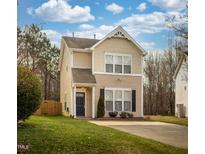 Charming two-story home with a well-manicured lawn and a cozy front entrance at 10809 Farmville Rd, Raleigh, NC 27614