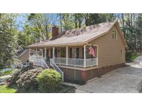 Charming traditional home with a welcoming front porch and manicured landscaping at 1208 Turner Farms Rd, Garner, NC 27529