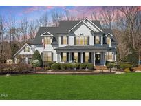 Charming two-story home with a beautifully landscaped yard and welcoming front porch at 1412 Wynncrest Ct, Raleigh, NC 27603
