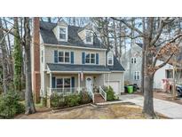 Charming two-story home with a welcoming front porch and well-manicured landscaping at 1701 Point Owoods Ct, Raleigh, NC 27604