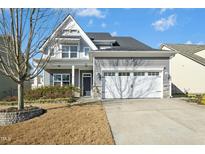Charming two-story home featuring gray siding, a two-car garage, and a well-maintained front yard at 1912 Pennypacker Ln, Durham, NC 27703