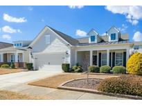 Charming single-Gathering home featuring a two-car garage, dormer windows, and landscaped yard at 2436 Fiddich Ln, Fuquay Varina, NC 27526