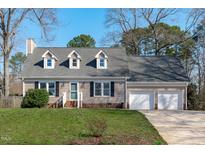 Charming single-Gathering home featuring a two-car garage, dormer windows, and a well-manicured lawn at 2828 Pidgeon Hill Rd, Raleigh, NC 27613