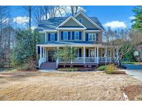 Charming two-story home boasts a welcoming front porch and well-maintained landscaping at 4001 Gatewood Falls Ct, Apex, NC 27539