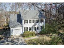 Two-story home featuring a gray roof, white exterior, garage, and well-maintained landscaping at 4204 New Brighton Dr, Apex, NC 27539