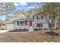 Charming home with a red front door, black shutters, and attached garage at 4307 Pope Rd, Durham, NC 27707