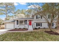 Charming two-story home with a red front door and meticulously maintained landscaping at 4307 Pope Rd, Durham, NC 27707