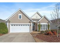Charming home with a two-car garage, inviting front porch, and beautiful landscaping at 512 Garendon Dr, Cary, NC 27519