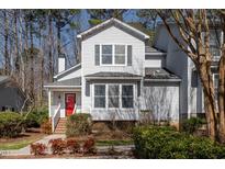Charming two-story home featuring gray siding, a bright red front door, and well-maintained landscaping at 595 Weathersfield # A, Pittsboro, NC 27312