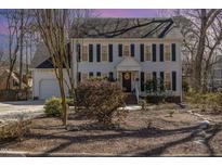 Charming two-story home featuring a well-manicured front yard and classic architectural details at 7508 Chippenham Ct, Raleigh, NC 27613