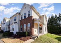 Charming townhouse with a brick facade, well-kept lawn, and inviting front entrance at 7841 Silverthread Ln, Raleigh, NC 27617