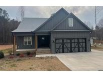 Charming single-story home with a two-car garage and a well-manicured front yard at 945 Lynch Rd, Selma, NC 27576