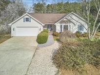 Charming one-story home with manicured landscaping, attached garage, and inviting entrance at 10 Eastwind Pl, Chapel Hill, NC 27517
