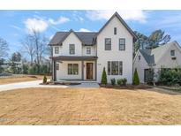 Striking two-story home with modern farmhouse design and lush front lawn and attractive landscaping at 109 W Markham Ave, Durham, NC 27701