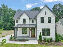 Charming two-story home with a manicured lawn and stylish architectural details at 109 W Markham Ave, Durham, NC 27701