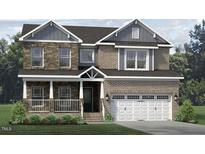 Charming two-story home featuring a welcoming front porch, brick and stone accents, and a two-car garage at 1098 Tulloch Ct # 209, Burlington, NC 27215