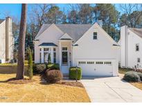 Charming single Gathering home with a manicured front lawn and attached two car garage at 111 Nuttree Way, Durham, NC 27713