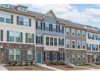 Charming townhomes featuring stone accents, multiple windows, and inviting entryways for a welcoming curb appeal at 1329 Channing Park Cir, Cary, NC 27519