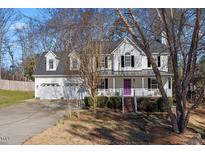 Charming two-story home featuring a two-car garage and inviting front porch with a purple door at 15 Rocky Point Ct, Fuquay Varina, NC 27526