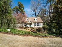 Charming Cape Cod home with dormer windows and a well-manicured lawn at 1708 Lakepark Dr, Raleigh, NC 27612