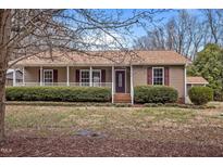 Charming single story home featuring a cozy front porch and well-maintained landscaping at 1723 Bahama Rd, Bahama, NC 27503