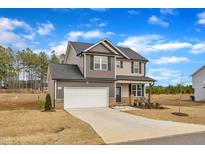 Charming two-story home featuring a two-car garage, well-maintained lawn, and inviting curb appeal at 252 Olde Place Dr, Zebulon, NC 27597