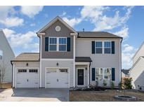 Charming two-story home with gray siding, dark shutters, and a two-car garage at 278 Bent Willow Dr, Clayton, NC 27527
