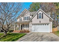 Charming two-story home with a two-car garage, manicured lawn, and traditional architectural details at 2812 Ashland Dr, Durham, NC 27705