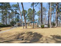 Charming exterior featuring a blue home with a brick foundation and a bright yellow front door at 300 Cliffview Dr, Knightdale, NC 27545