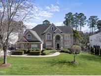 Beautiful brick home with manicured lawn, mature trees, and an inviting entrance at 305 Southmoor Oaks Ct, Cary, NC 27518