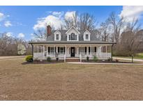 Charming two-story home with a welcoming front porch and traditional architectural details at 3068 Benson Rd, Angier, NC 27501