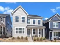 Charming two-story home with light gray siding and a welcoming front porch at 372 Natsam Woods Way, Wake Forest, NC 27587