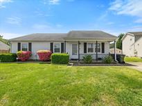 Charming single-story home with a well-manicured lawn and blooming shrubbery at 4 Hannah Ct, Durham, NC 27713