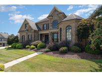 Beautiful brick home featuring a manicured lawn and stone accents at 5026 Clyden Cv, Raleigh, NC 27612