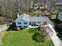 Charming home with a well-manicured lawn, surrounded by mature trees offering a blend of privacy and curb appeal at 6812 Valley Dr, Raleigh, NC 27612