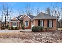 Charming single Gathering home featuring brick exterior, black shutters, and manicured landscaping at 715 Thompson Rd, Garner, NC 27529