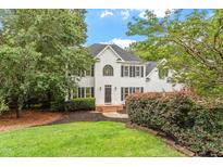 Charming two-story home with a well-manicured lawn and mature landscaping, creating an inviting curb appeal at 725 Littleleaf Ct, Holly Springs, NC 27540