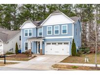 Charming two-story home featuring blue siding, white trim, and a well-manicured front yard at 741 Moonbeam Dr, Raleigh, NC 27603